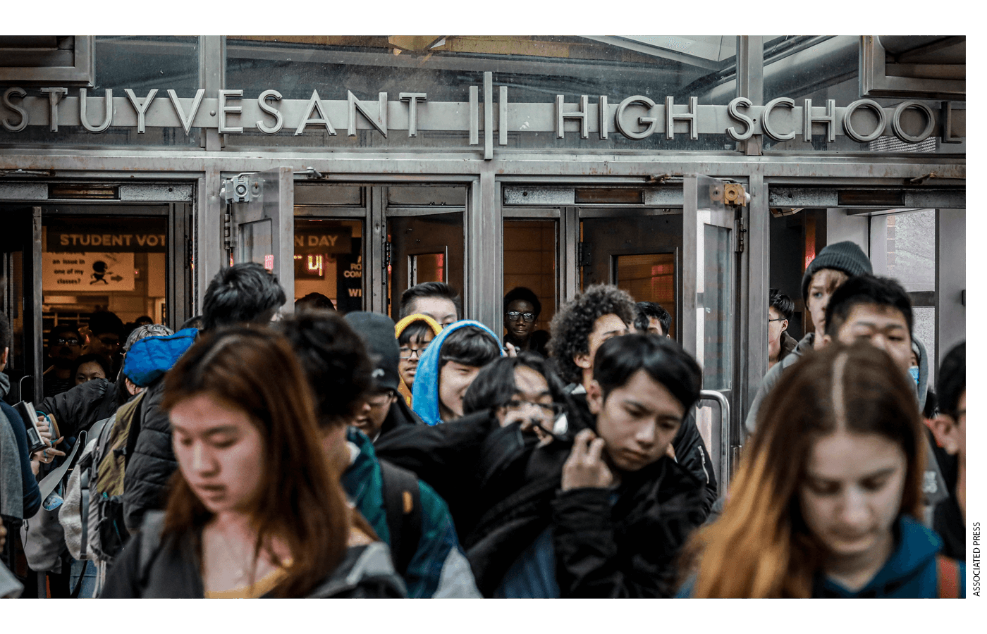 Students at Stuyvesant High School leave after classes end for the week, March 13, 2020, in New York.