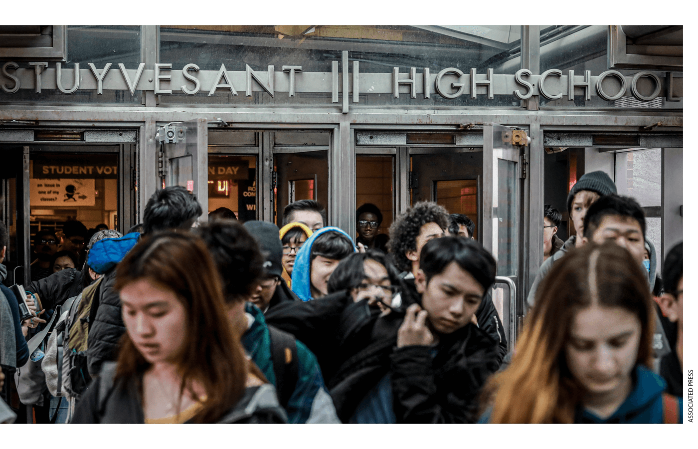 Students at Stuyvesant High School leave after classes end for the week, March 13, 2020, in New York. 