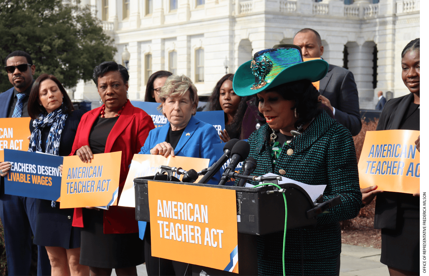 Teachers Union Leaders Becky Pringle and Randi Weingarten look on earlier this month as a member of Congress, Frederica Wilson, speaks about legislation that would raise starting teacher pay to $60,000 a year.