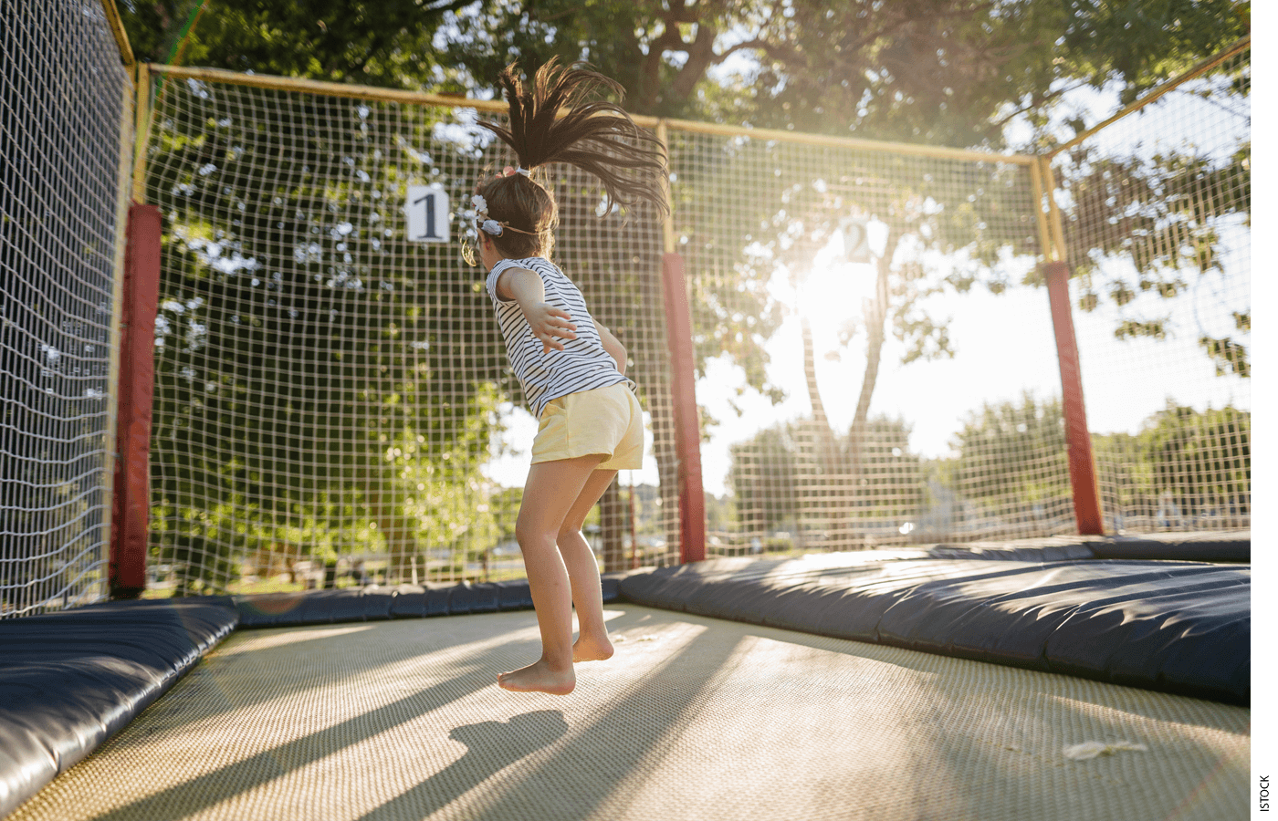 A child playing on a trampoline
