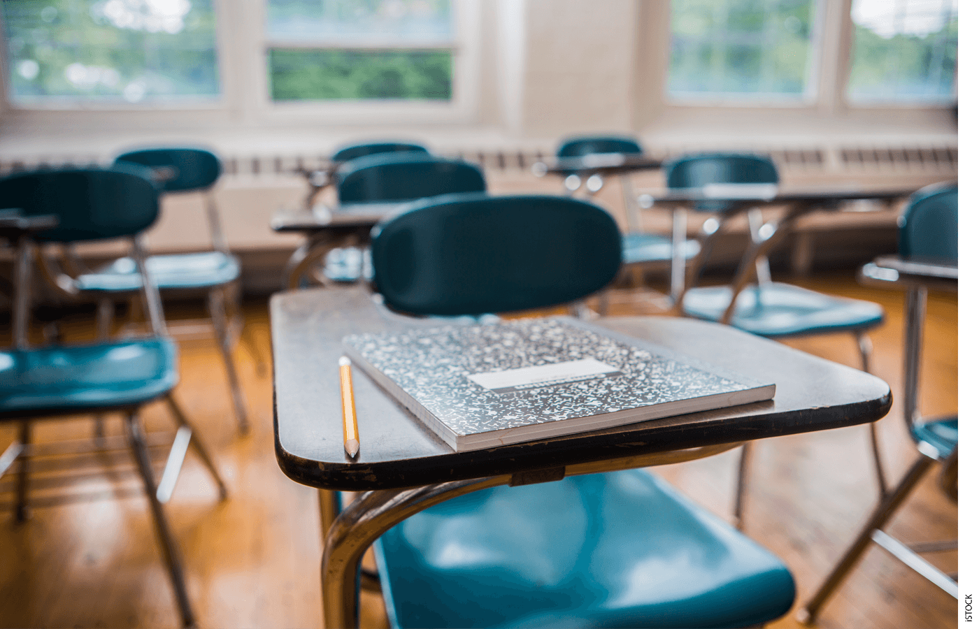 An empty seat and desk in a classroom