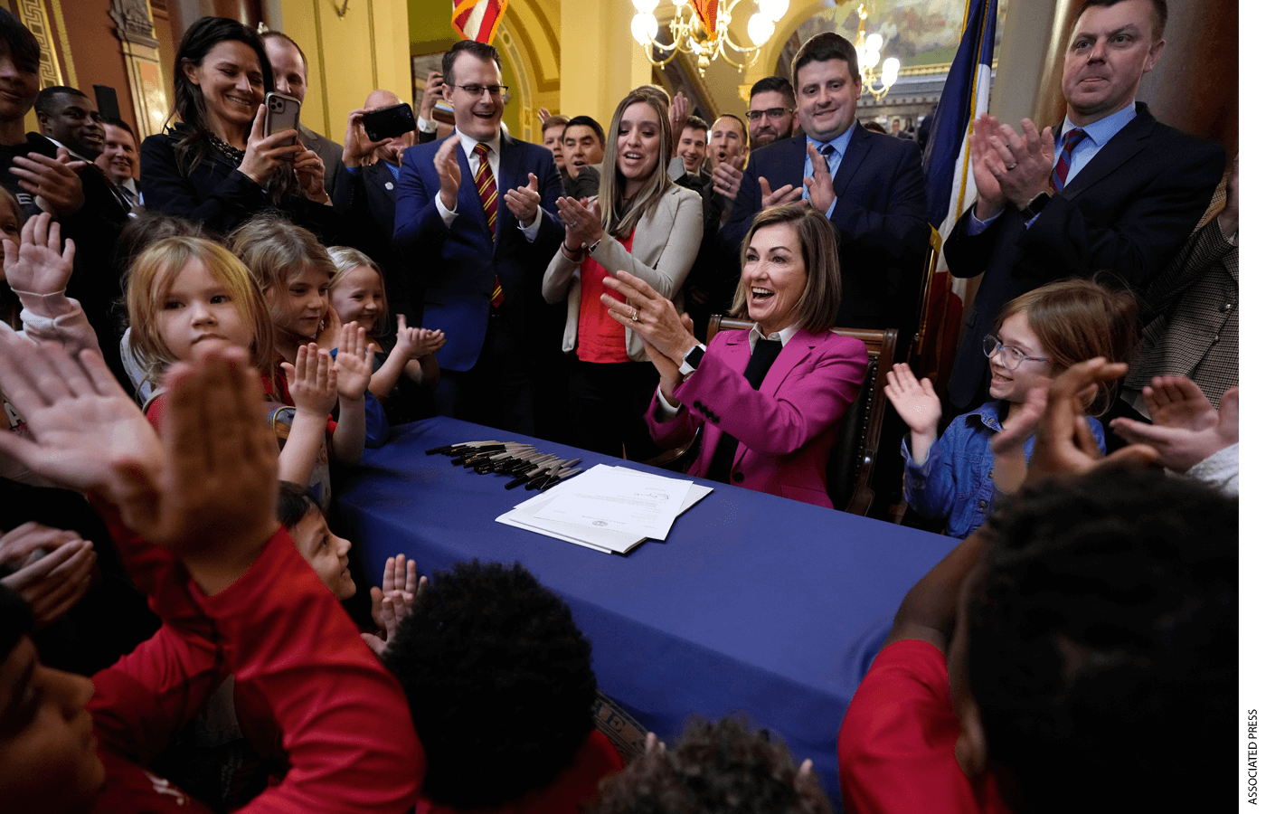 Iowa Governor Kim Reynolds reacts after signing a bill that creates education savings accounts, Tuesday, Jan. 24, 2023, at the Statehouse in Des Moines, Iowa.