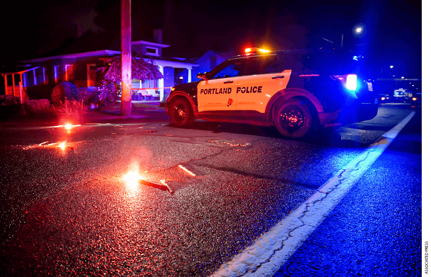 A Portland police car on a road at night