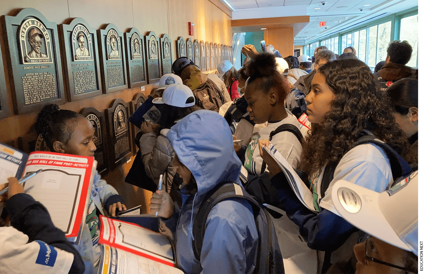 Students from the 6th grade at Nathan Hale School complete a “bingo challenge” as part of the Red Sox Hall of Fame stop on their guided tour of the Fenway Park Learning Lab.