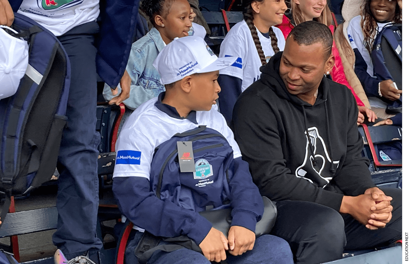 Red Sox third baseman Rafael Devers speaks with a 6th grade student from Nathan Hale School at a kickoff event for Fenway Park Learning Lab.