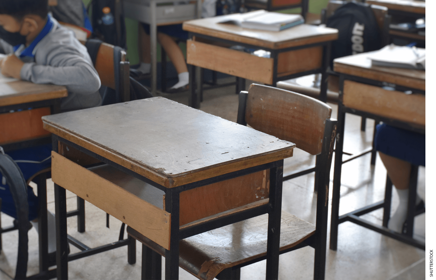 An empty desk in a classroom
