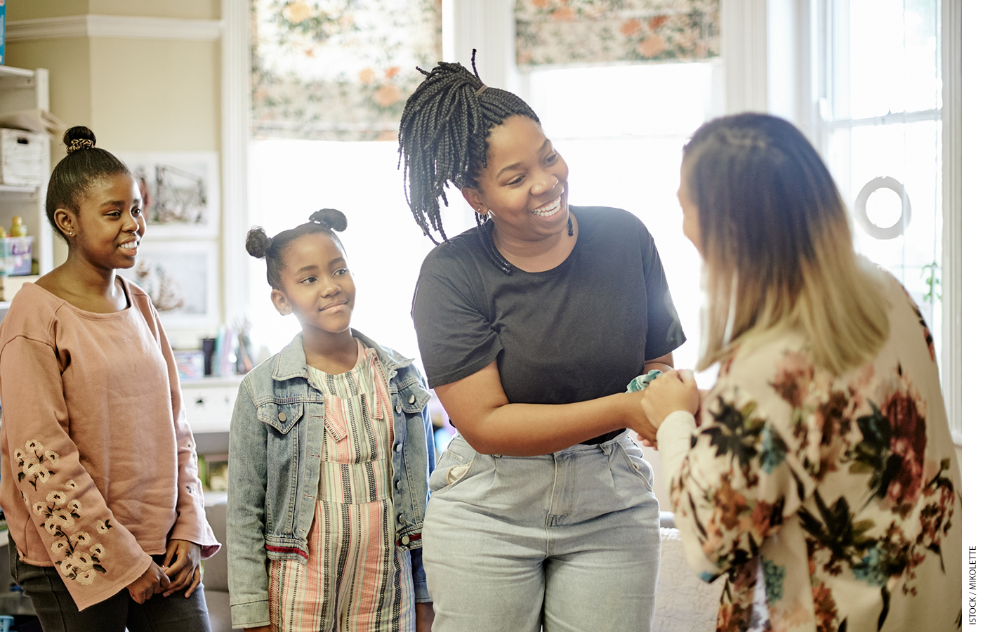 Parent with children meets teacher