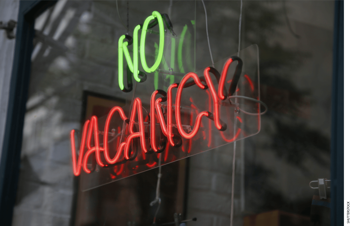 Neon sign in a window that reads "No Vacancy"