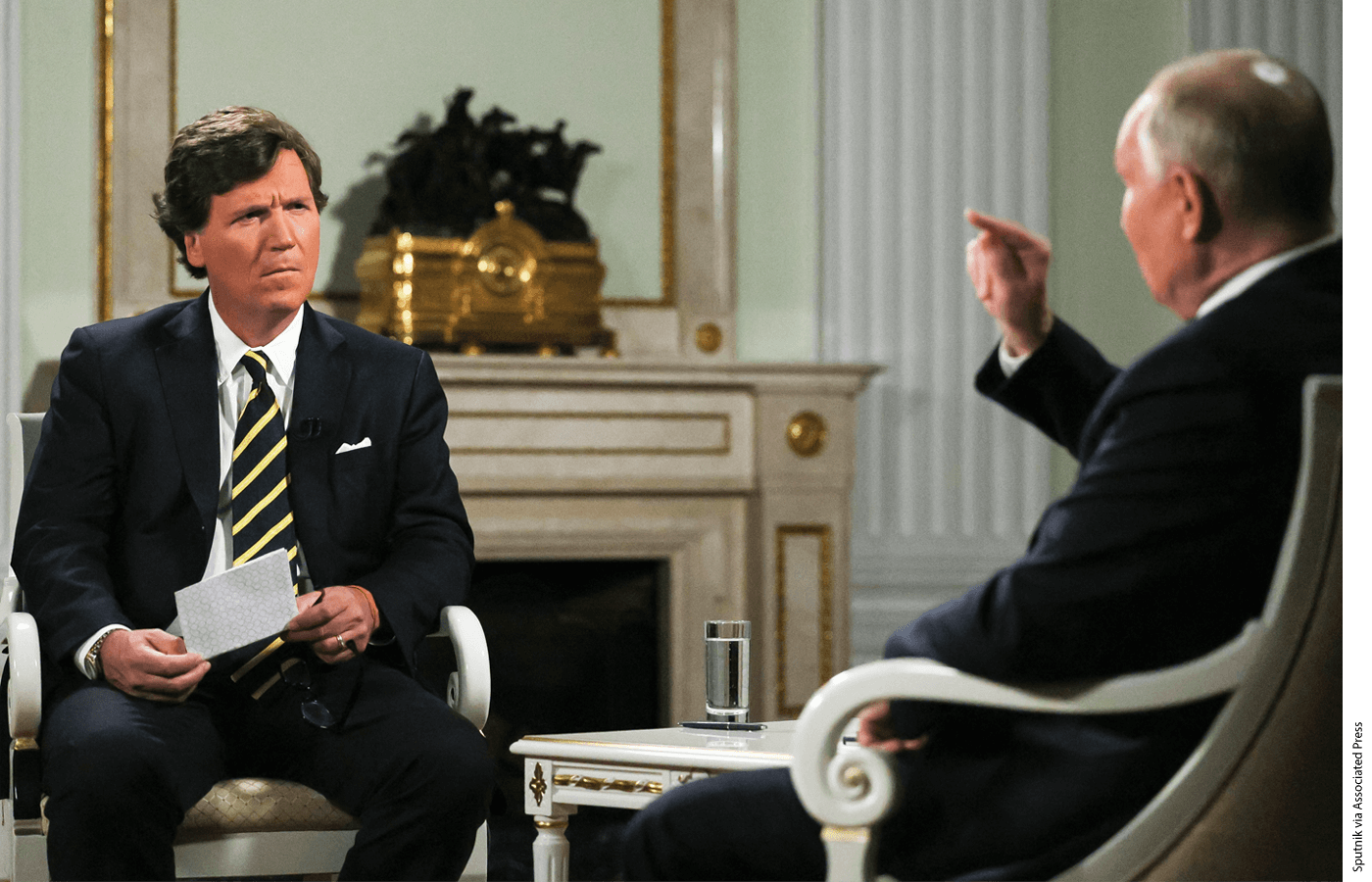 Russian President Vladimir Putin, right, gestures as he speaks during an interview with former Fox News host Tucker Carlson at the Kremlin in Moscow, Russia, Tuesday, Feb. 6, 2024.