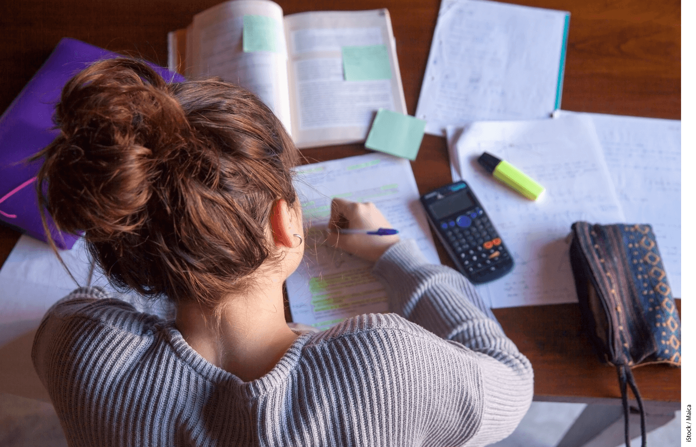 Stock photo of a teenager doing homework