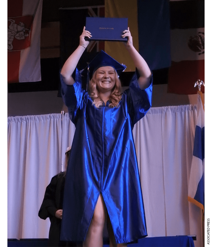 Graduate Marissa Schilling holding a diploma