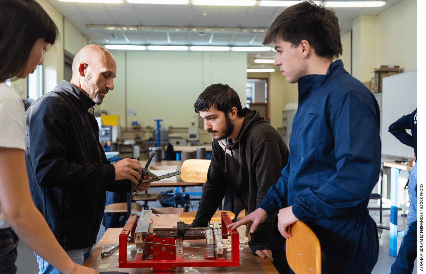 Students watch an instructor in a shop class