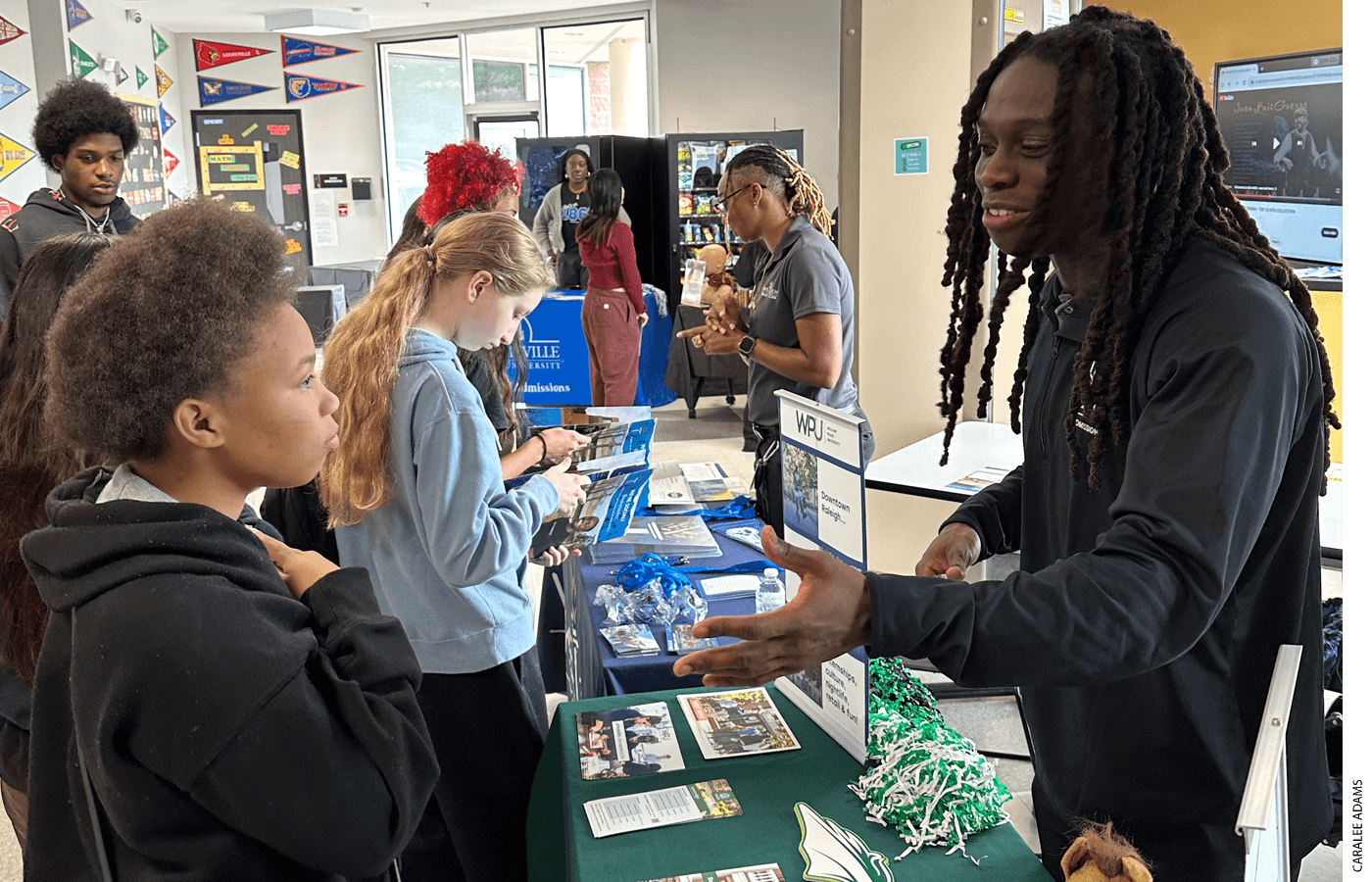 Central Wake 10th grader Shakkya Barksdale-Anderson gathers information about William Peace University, a private college in Raleigh, from admissions counselor Donolique Tyrell during a college fair last October.