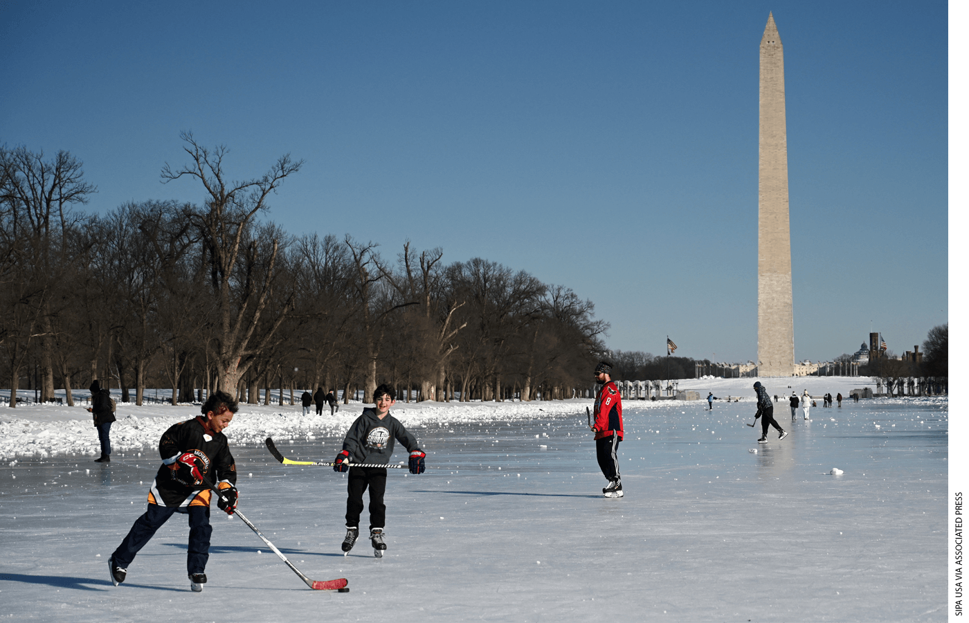  Kids play hockey on the frozen Lincoln Memorial Reflecting Pool on Monday, February 2, eight days after the snowstorm shut down many D.C.-area public schools.