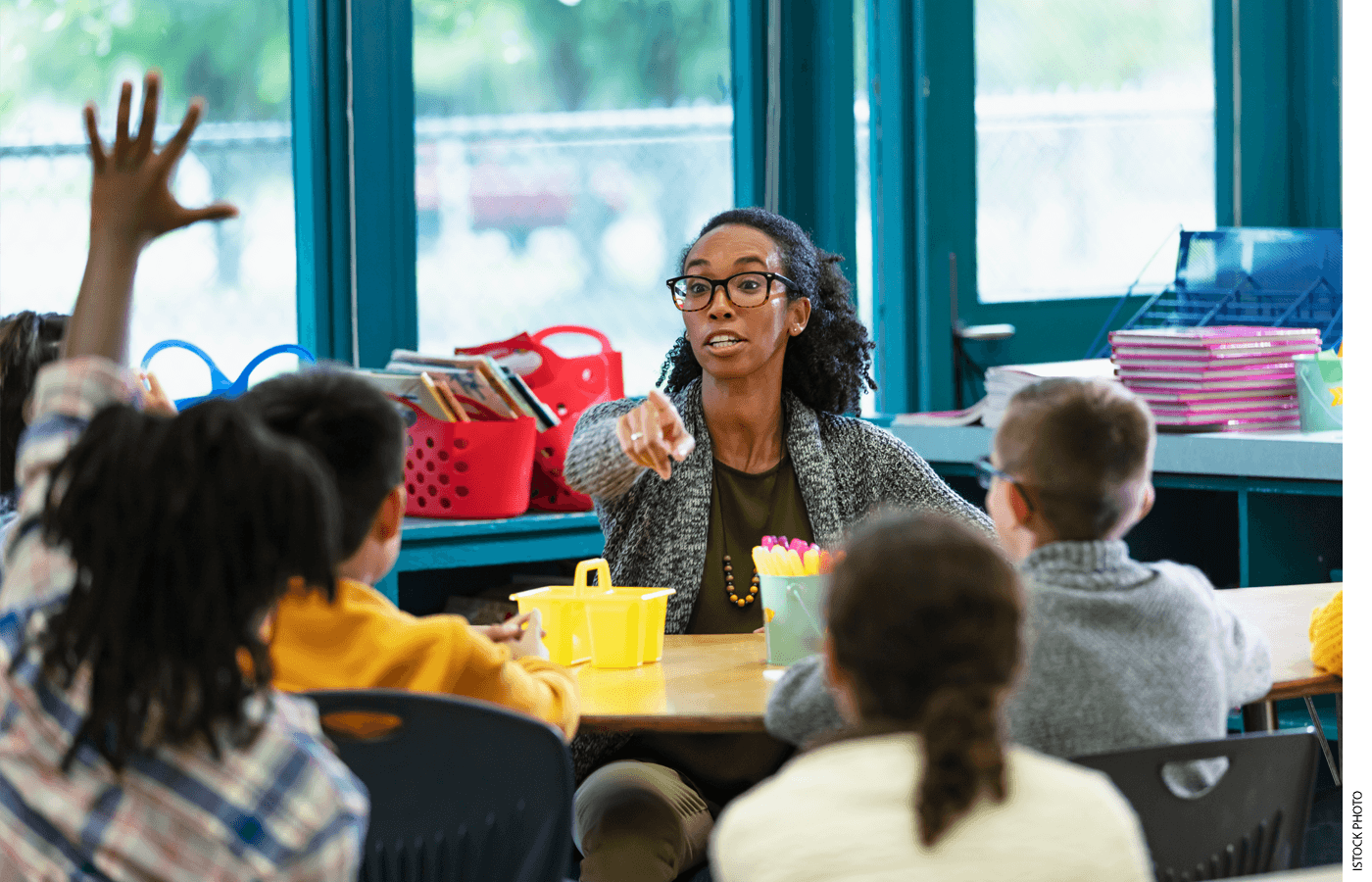 A teacher acknowledges a student in class