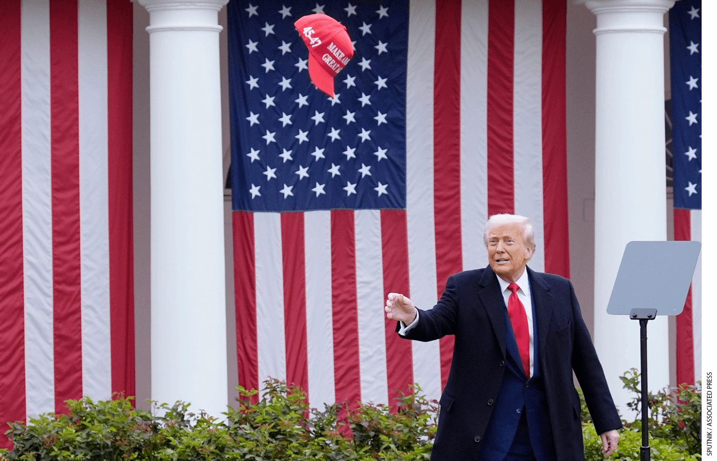 Donald Trump throws a hat in the air