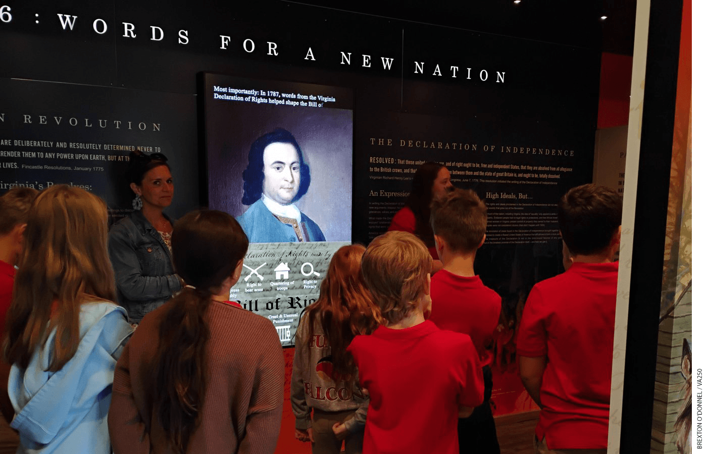 Group of students gathered in a museum exhibit about Revolutionary War