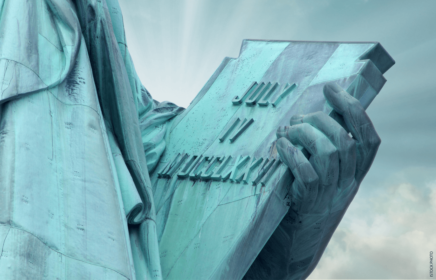 Close-up image of tablet held by the Statue of Liberty showing "July 4, 1776" in Roman numerals.