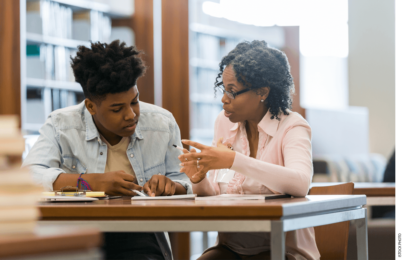 A teacher works with a student one-on-one