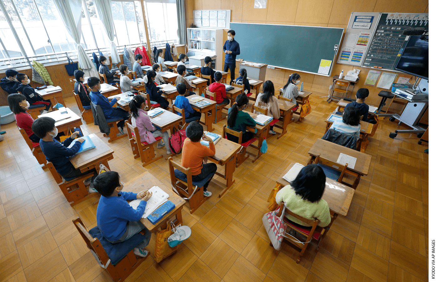 Students and teachers return to class at a reopened elementary school in Shizuoka, Japan, on March 16, 2020, about two weeks after the school shut down temporarily to prevent the spread of the novel coronavirus.
