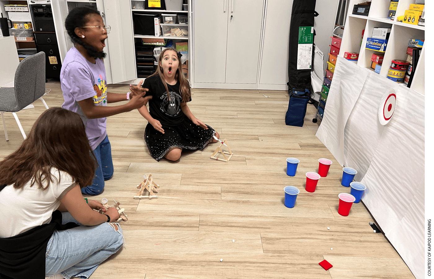 Middle schoolers at a KaiPod learning center in Gilbert, Arizona, react to a catapult experiment.