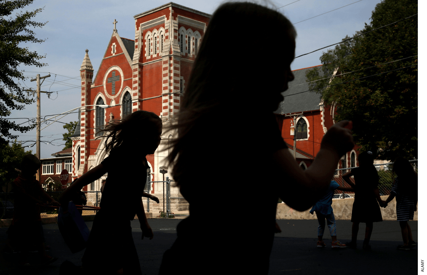 Catholic schoolchildren play during recess across from their school in suburban Chicago in 2018.